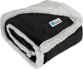 Black reversible sherpa dog blanket folded showing soft dark fleece exterior and fluffy white sherpa lining for warmth and pet comfort