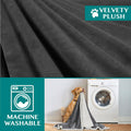 Close up of velvety plush reversible sherpa dog blanket fabric with machine washable feature shown next to washing machine and dog