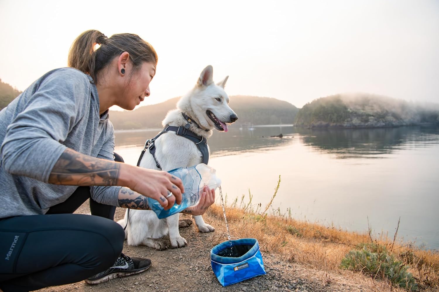 Collapsible Dog Bowl being filled with water outdoors, perfect for travel and hiking with pets.